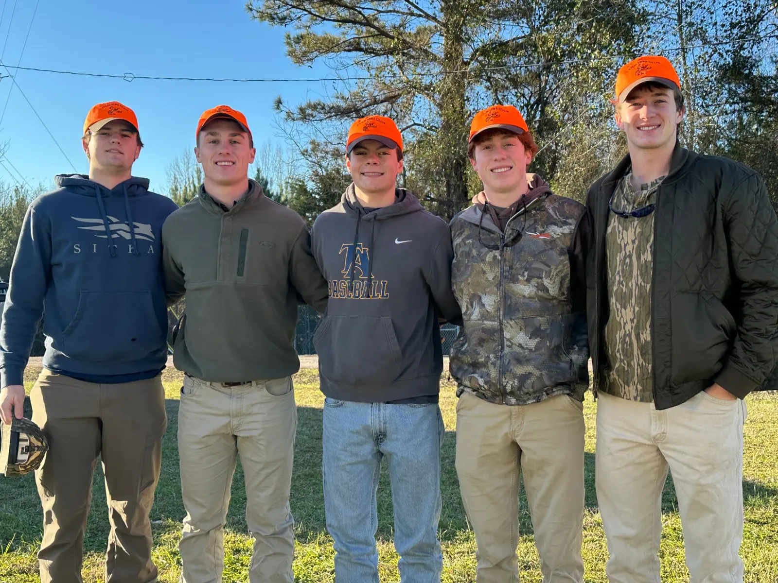 Five volunteers in Coursers Club blaze orange caps on event day